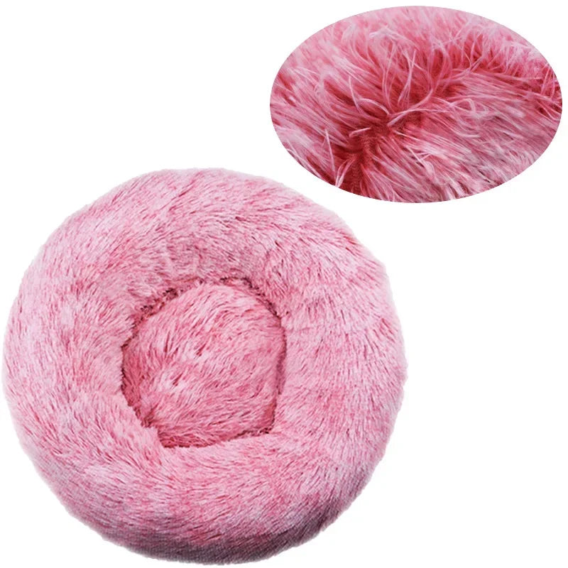 Round pink fluffy pet bed with soft plush texture and raised rim design.