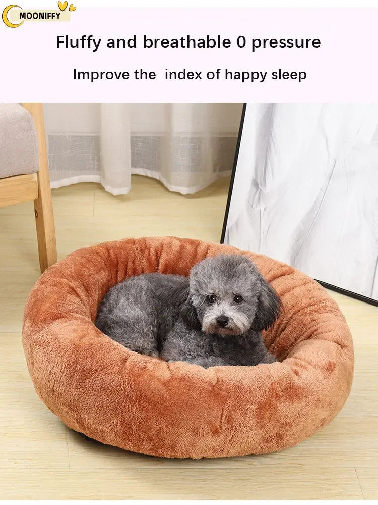 Gray dog lying in a round, fluffy, brown pet bed in a cozy indoor setting
