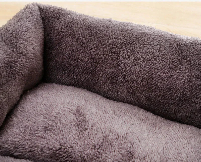 Close-up of soft, plush gray pet bed with fluffy, cozy texture on wooden floor