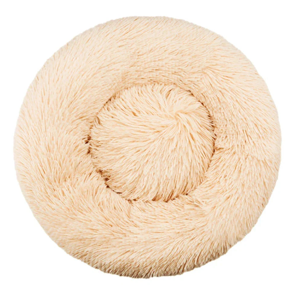 Round fluffy beige pet bed with plush faux fur, donut shape for cats or small dogs