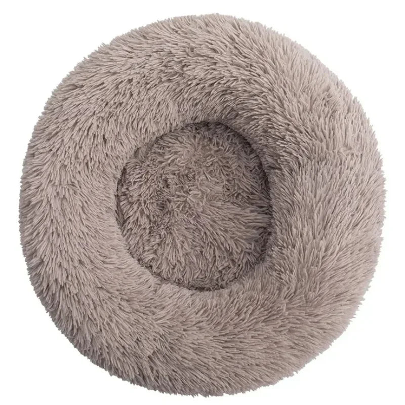 Round fluffy taupe pet bed with raised rim and plush texture, ideal for cats or small dogs.